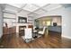 Open-concept living space with hardwood floors, a stone fireplace, and access to the kitchen at 518 Ranch Farm Rd, Raleigh, NC 27603