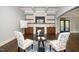 Elegant living room featuring a stone fireplace, hardwood floors, and coffered ceilings at 518 Ranch Farm Rd, Raleigh, NC 27603