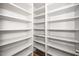 Walk-in pantry with custom built-in white shelving and hardwood flooring at 518 Ranch Farm Rd, Raleigh, NC 27603
