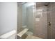 Tiled shower with a glass door, bench, and showerhead at 518 Ranch Farm Rd, Raleigh, NC 27603