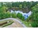 Scenic aerial view of community lake surrounded by lush greenery and a walking trail at 521 Rockcastle Dr, Cary, NC 27519