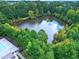 Overhead view of a serene lake nestled within a vibrant, tree-filled residential community at 521 Rockcastle Dr, Cary, NC 27519
