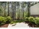 Cozy back patio featuring a wooded view and professional landscaping for privacy and relaxation at 521 Rockcastle Dr, Cary, NC 27519