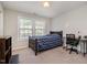 Comfortable bedroom with a large window, a desk, and neutral carpet at 521 Rockcastle Dr, Cary, NC 27519
