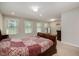 Bright bedroom with multiple windows and a wooden bed dressed with a red patterned comforter at 521 Rockcastle Dr, Cary, NC 27519
