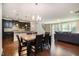 Open-concept dining room with hardwood floors adjacent to the kitchen and living room at 521 Rockcastle Dr, Cary, NC 27519