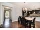 Dining area open to the kitchen with a chandelier and natural light at 521 Rockcastle Dr, Cary, NC 27519