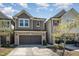 Charming townhome with brick accents, attached garage, and well-manicured landscaping at 521 Rockcastle Dr, Cary, NC 27519