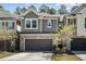 Charming exterior featuring a brick and siding facade, attached garage, and manicured front lawn at 521 Rockcastle Dr, Cary, NC 27519