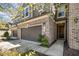 Stylish brick and siding townhome featuring a two-car garage and covered entry at 521 Rockcastle Dr, Cary, NC 27519