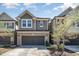 Charming brick and siding two-story townhouse with an attached two-car garage at 521 Rockcastle Dr, Cary, NC 27519