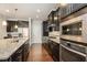 Modern kitchen with stainless steel appliances, granite countertops and dark wood cabinets at 521 Rockcastle Dr, Cary, NC 27519