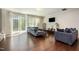 Bright living room with hardwood floors, neutral walls, and a sliding glass door at 521 Rockcastle Dr, Cary, NC 27519