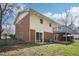 Exterior of two-story home with brick accents and a deck overlooking the backyard at 5218 Revere Rd, Durham, NC 27713