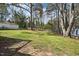 Large backyard with mature trees and a shed in the background at 5218 Revere Rd, Durham, NC 27713
