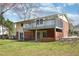 Exterior view of the two-story home with a deck and sliding glass door to the basement at 5218 Revere Rd, Durham, NC 27713