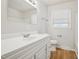 A bright bathroom features a large vanity and mirror, complemented by natural light from the window at 5218 Revere Rd, Durham, NC 27713