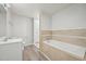 Bright bathroom with a large tub and tiled walls at 5218 Revere Rd, Durham, NC 27713