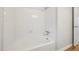Clean bathroom with a white tiled shower and tub combo, offering a simple and functional design at 5218 Revere Rd, Durham, NC 27713