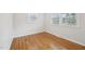 A bright bedroom has hardwood floors and two windows, creating a cozy space for relaxation at 5218 Revere Rd, Durham, NC 27713