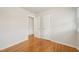 A spacious bedroom features hardwood floors, white walls, and closet doors, creating a serene atmosphere at 5218 Revere Rd, Durham, NC 27713