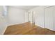 Well-lit bedroom with sleek hardwood floors and ensuite bath access at 5218 Revere Rd, Durham, NC 27713