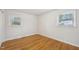 The neutral bedroom offers natural light and hardwood floors at 5218 Revere Rd, Durham, NC 27713