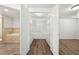 Open closet shows adjustable metal shelving, with a peek into bathroom and living area at 5218 Revere Rd, Durham, NC 27713
