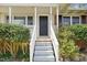 Welcoming front porch and entrance featuring classic columns and a freshly painted door at 5218 Revere Rd, Durham, NC 27713
