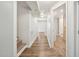 Bright hallway with wood-look flooring leads to stairs and bathroom at 5218 Revere Rd, Durham, NC 27713