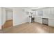 Open kitchen featuring white cabinets, stainless steel appliances, and a view to the entry door at 5218 Revere Rd, Durham, NC 27713