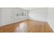 Large windows provide ample natural light in this room, complete with hardwood floors at 5218 Revere Rd, Durham, NC 27713