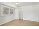 Bright living room with two large windows, wood-look floors, and neutral paint, creating a welcoming space at 5218 Revere Rd, Durham, NC 27713