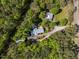 Aerial view of a home and a separate cabin, nestled in a lush forest at 5401 Friends School Rd, Durham, NC 27705