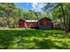 Large backyard with green grass, wooden deck, shed, and the house at 5401 Friends School Rd, Durham, NC 27705