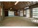 Spacious barn interior with concrete floor and wooden beam framework, providing ample storage and workspace at 5401 Friends School Rd, Durham, NC 27705