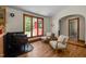 Living room with gas fireplace, wood floors, and arched doorway leading to bathroom at 5401 Friends School Rd, Durham, NC 27705