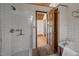 Bathroom features a clawfoot tub, walk in shower and a wooden framed doorway at 5401 Friends School Rd, Durham, NC 27705