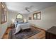 Comfortable bedroom with hardwood floors, a ceiling fan, and large windows, offering a relaxing retreat at 5401 Friends School Rd, Durham, NC 27705