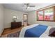 Bright bedroom featuring a wood dresser, hardwood floors, a ceiling fan, and large windows with views at 5401 Friends School Rd, Durham, NC 27705