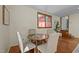 Charming dining area with seating for four, hardwood floors, a window, and access to the backyard at 5401 Friends School Rd, Durham, NC 27705