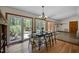 Dining room with wood floors, exterior doors, and views of lush greenery at 5401 Friends School Rd, Durham, NC 27705