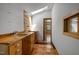 Hallway featuring custom wood cabinets, sink, and skylight offering plenty of natural light at 5401 Friends School Rd, Durham, NC 27705