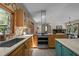 Bright kitchen with stainless steel oven, granite counters, and views to other living areas at 5401 Friends School Rd, Durham, NC 27705