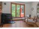 Living room with gas fireplace, wood floors, and large window with exterior views at 5401 Friends School Rd, Durham, NC 27705