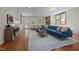 Inviting living room with hardwood floors, a comfortable blue sofa, and well-placed furniture for relaxing at 5401 Friends School Rd, Durham, NC 27705