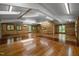 Spacious room features wood paneled walls, hardwood floors, and ample natural light at 5401 Friends School Rd, Durham, NC 27705