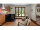 Cozy living room with wood floors, gas fireplace, and large window with exterior views at 5401 Friends School Rd, Durham, NC 27705