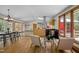 Open living space with wood floors, dining area, kitchen, fireplace, and natural light at 5401 Friends School Rd, Durham, NC 27705