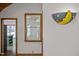 Arched doorway with half moon lamp, wooden window frames and views of the outdoors at 5401 Friends School Rd, Durham, NC 27705